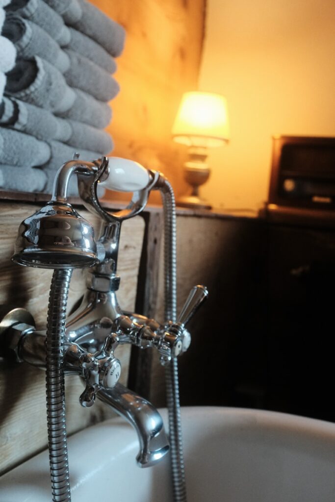 A bathroom sink with a faucet and soap dispenser